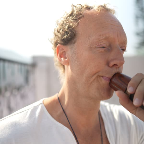 Close-up of Tomas playing the didgeridoo